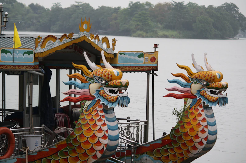 Painted dragon heads on the bows of two dragon boats