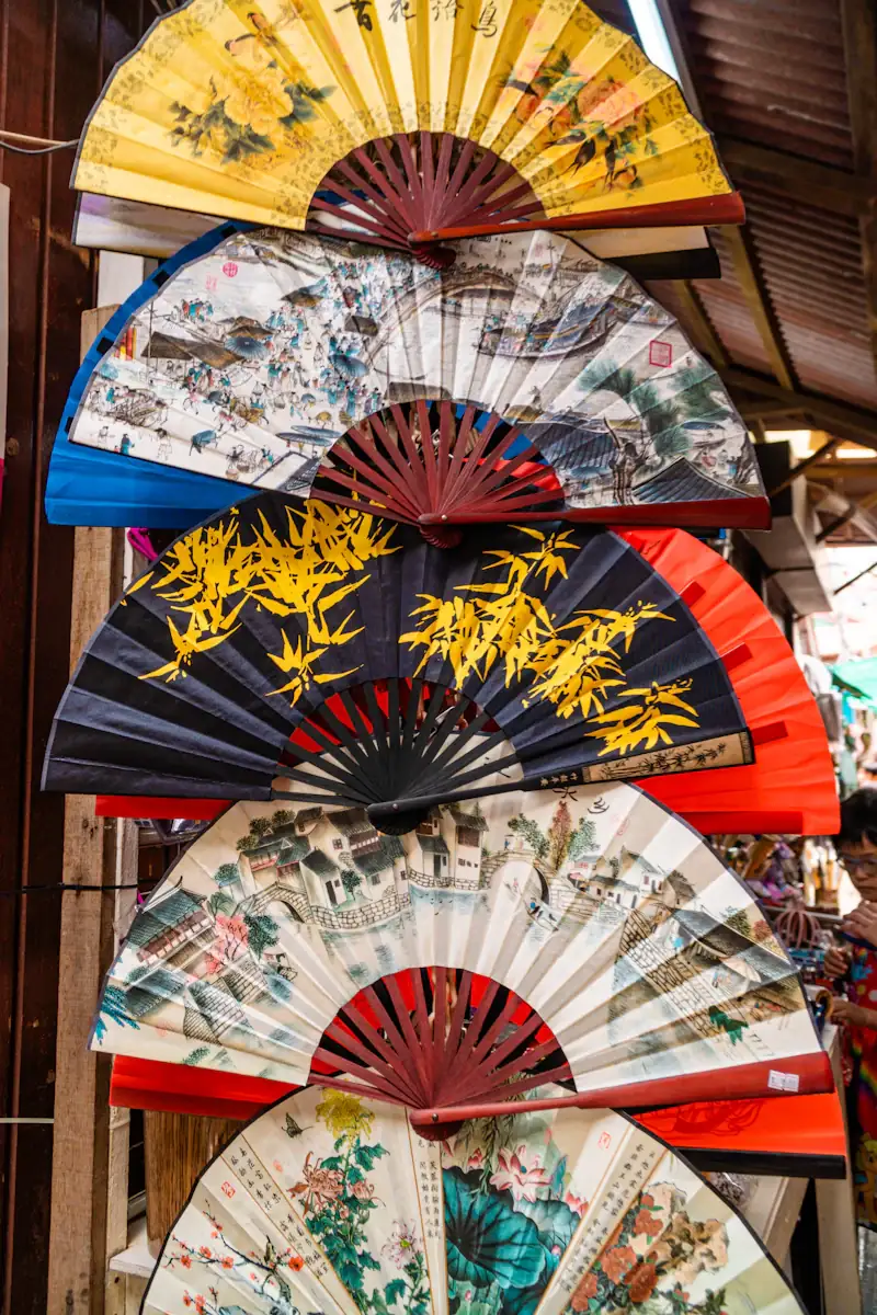 Colourful painted folding fans on display