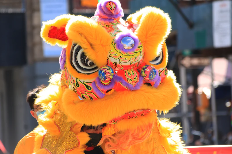 A yellow lion dance head with big eyes