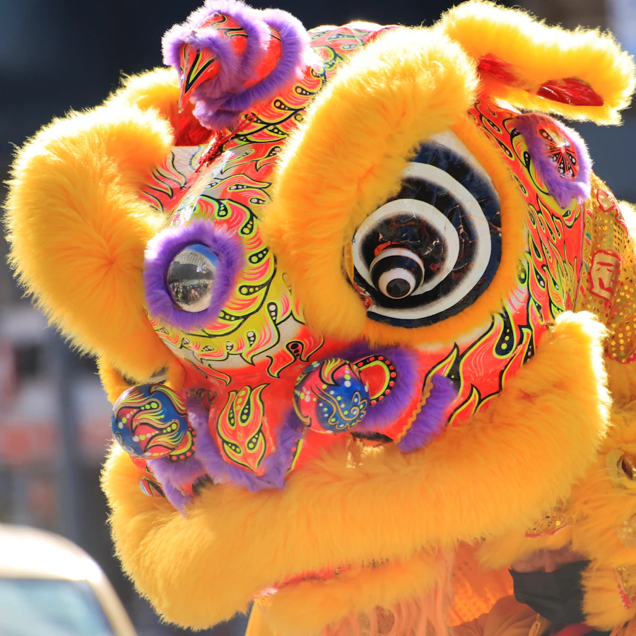 A bright yellow lion dance head