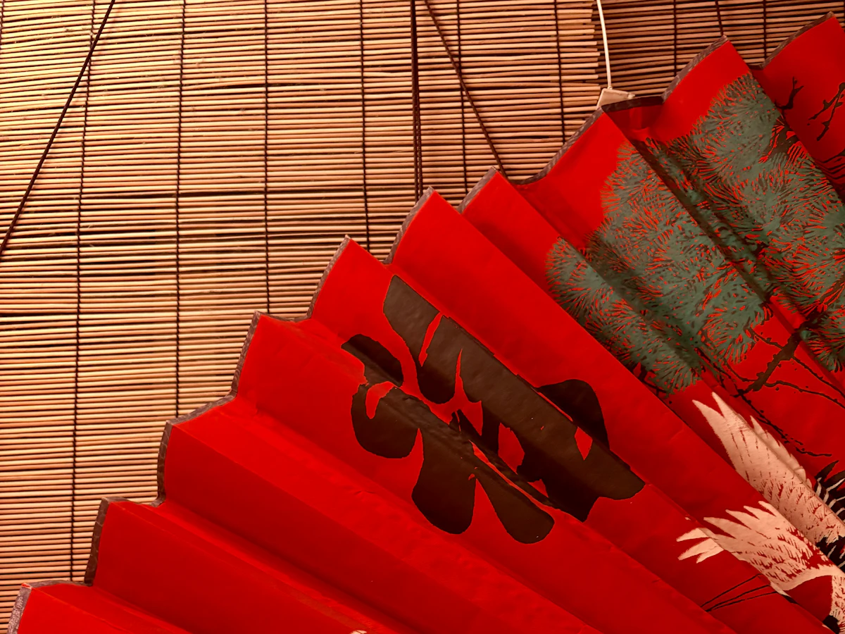 A red fan painted with cranes